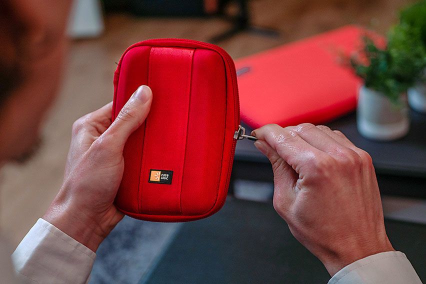 A close-up of someone closing a Case Logic electronics case.